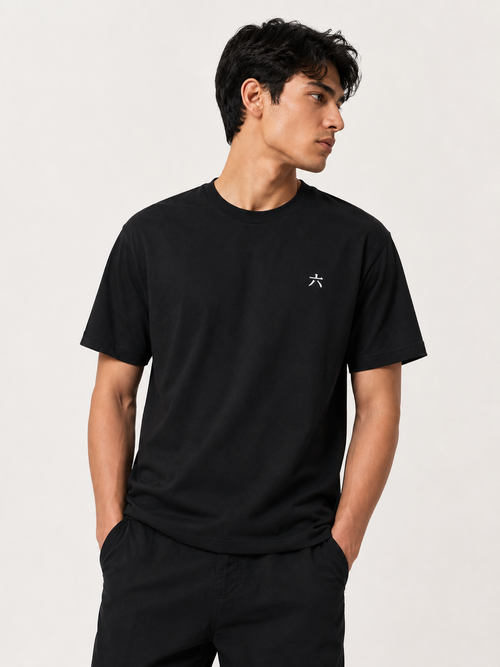 Male model wearing the BLACK 6SENSE by ROKURA oversized t-shirt with minimalist kanji logo on the chest.