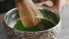 Procedural demonstration of the ROKURA initialization protocol: Aerating Edition 01 matcha using a traditional bamboo chasen in a high-frequency "W" motion to achieve peak foam density.