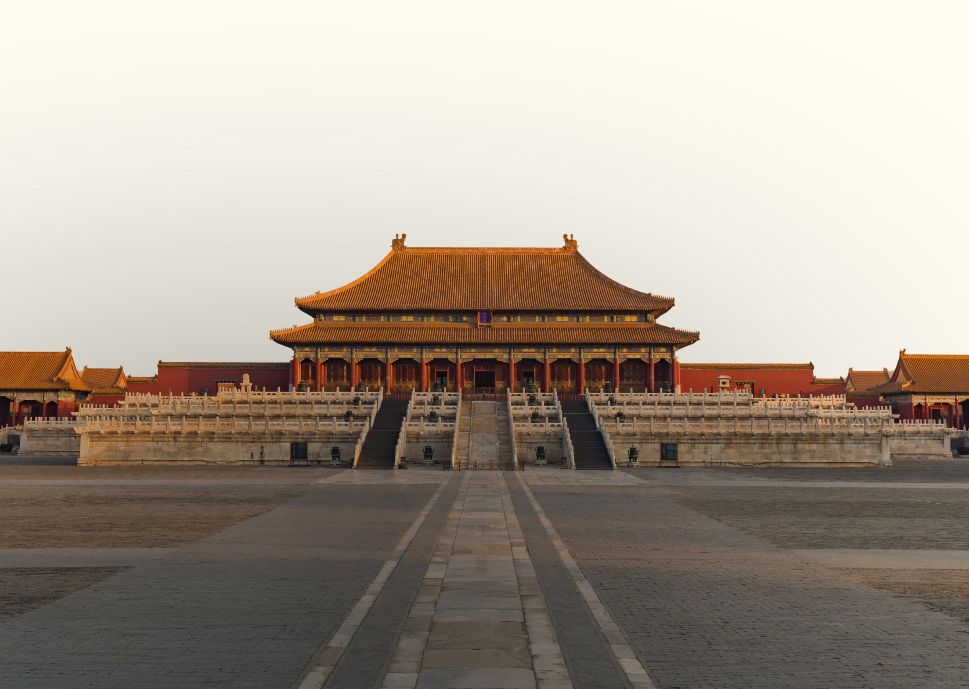 Traditional Chinese architecture with a large building in the center under a clear sky.